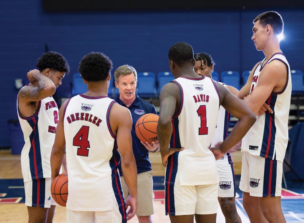 Head coach Dusty May advises the FAU players on strategy as the team prepares to compete during the 2023-24 season with the goal of securing a slot in the NCAA Final Four playoffs and a national championship title. Photo by Steven Martine